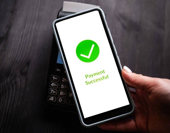 Successful Payment Process On A Smartphone Screen While Paying With A Wireless Terminal